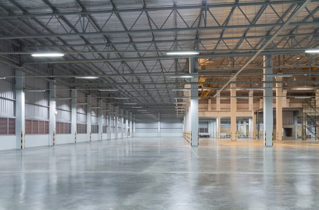 Empty factory building or warehouse building with concrete floor for industry background.
