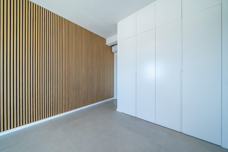 Room with wooden wall texture with wood acoustic panels pattern and closet