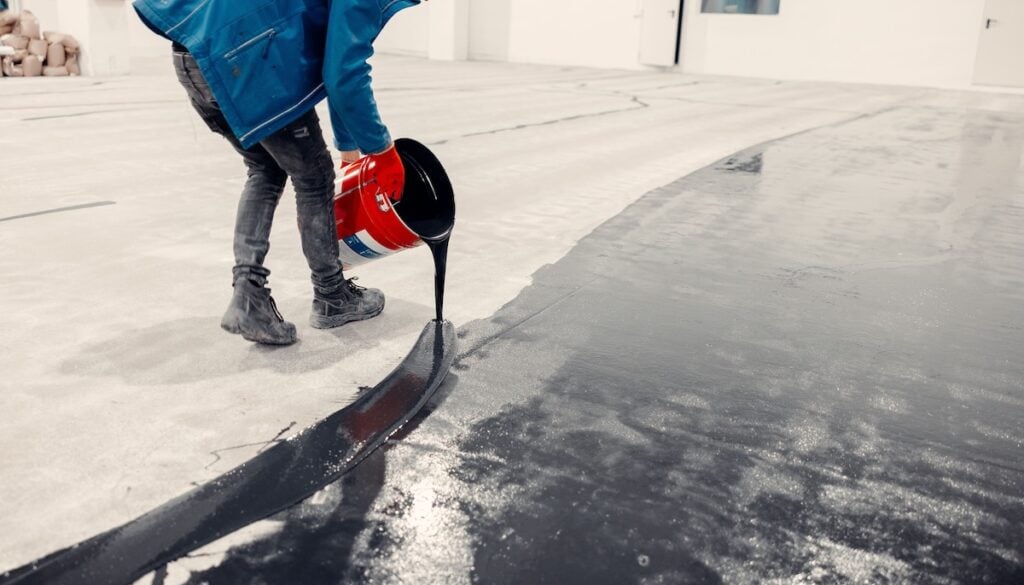 black epoxy floor Epoxy resin flooring installation in progress.