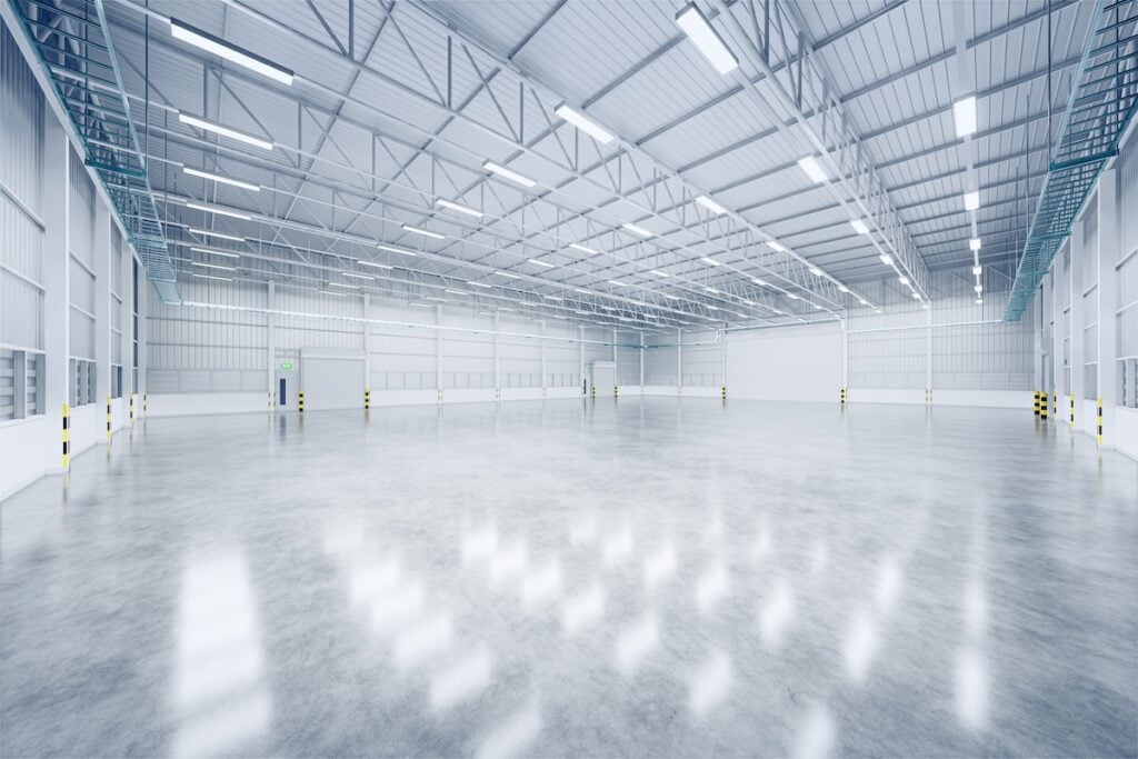 large-scale epoxy flooring installation 3d rendering of empty warehouse and shutter door and concrete floor for industrial background.