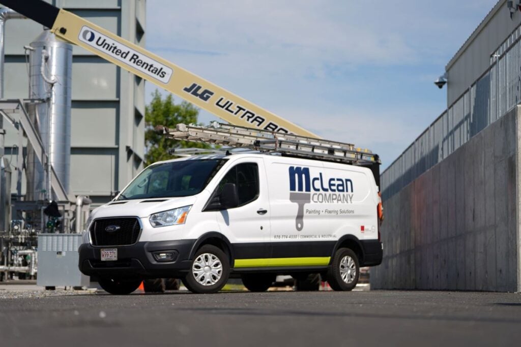 what type of sand is used for sandblasting McLean company branded truck behind industrial plant