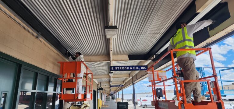 Mclean Workers on lifts painting ceiling