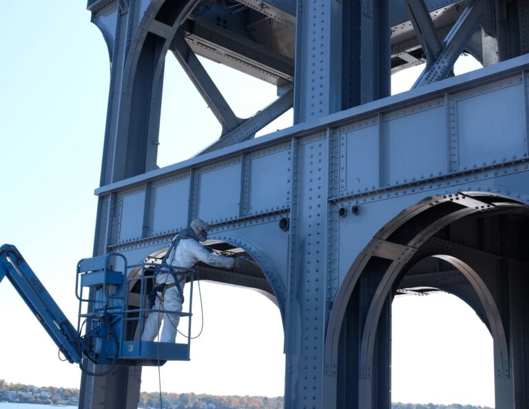 Mclean worker on a lift painting metal structure