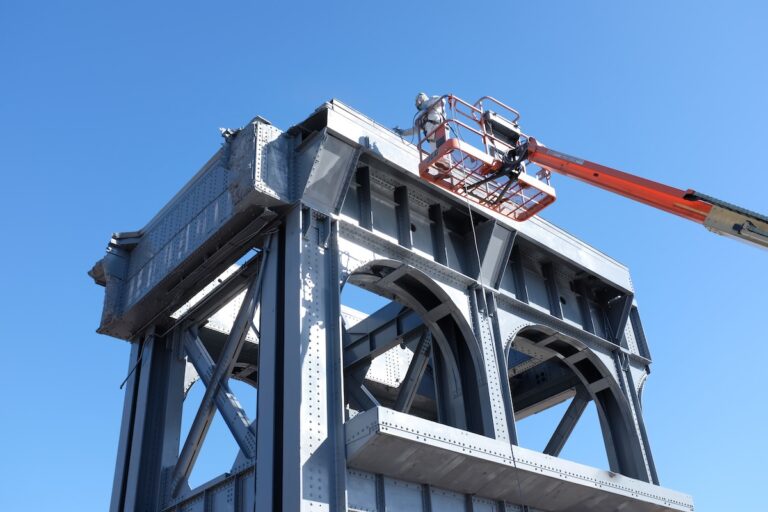 Worker on lift at bridge construction