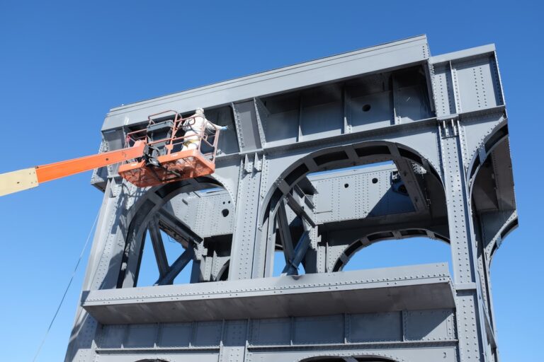 Mclean worker painting metal structure