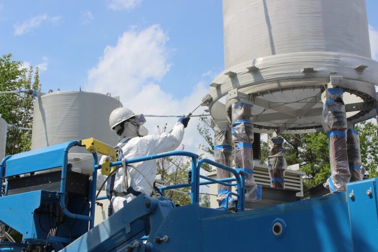 Mclean worker industrial painting a structure