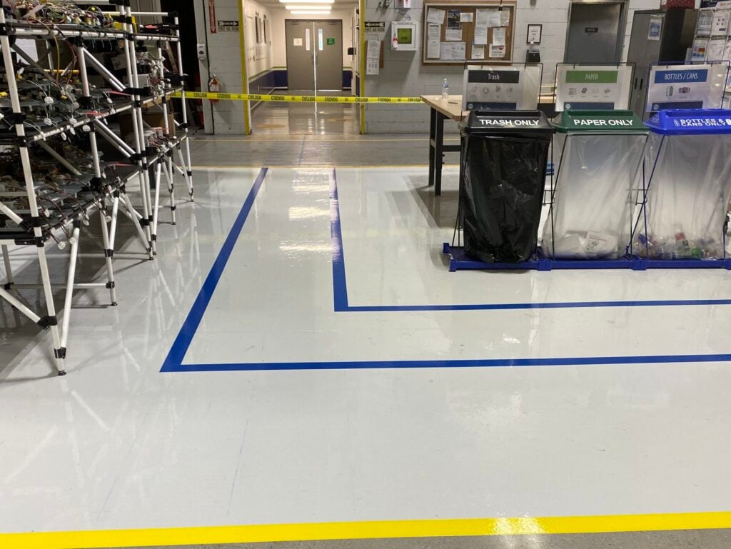 line striping machine blue lines inside warehouse shiny floor