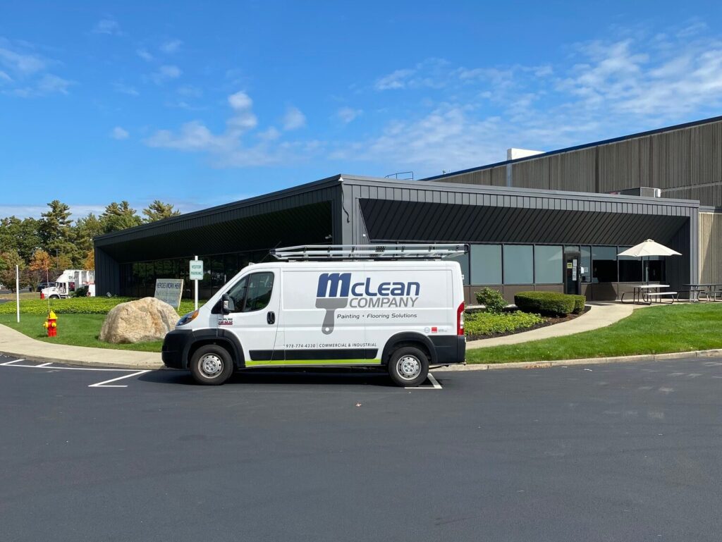 elastomeric coating branded van parked outside building