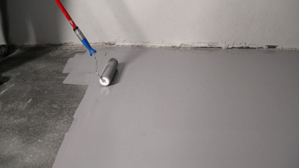 garage floor epoxy colors person applying using brush dark grey and white wall