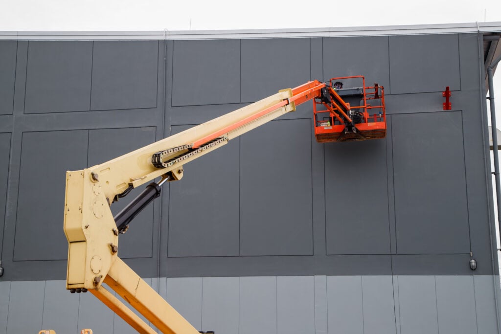 commercial painting prices Elevated pedestrian overground crossing tunnel facade painting using a telescopic boom lift with a basket