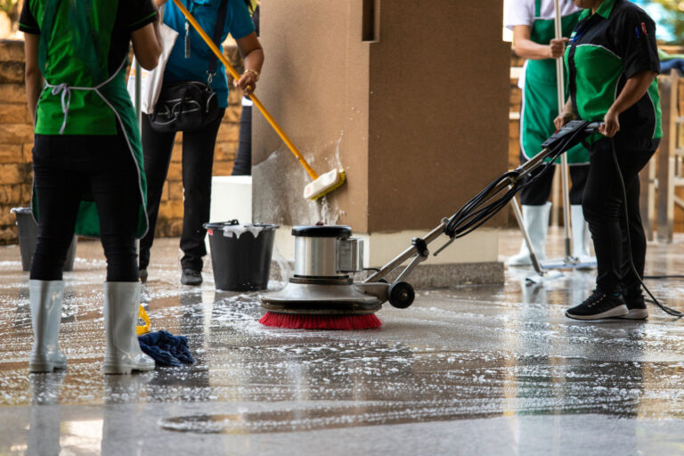 how to clean concrete floors The workers cleaning floor exterior walkway using polishing machine and chemical or acid