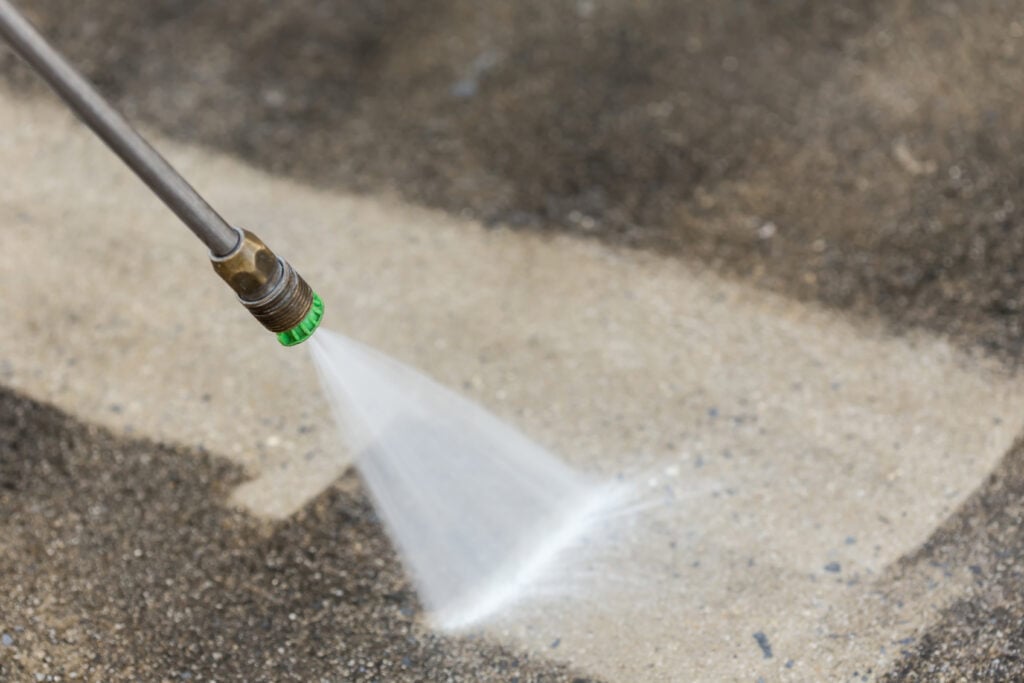 how to clean concrete floors Close up Outdoor floor cleaning with high pressure water jet
