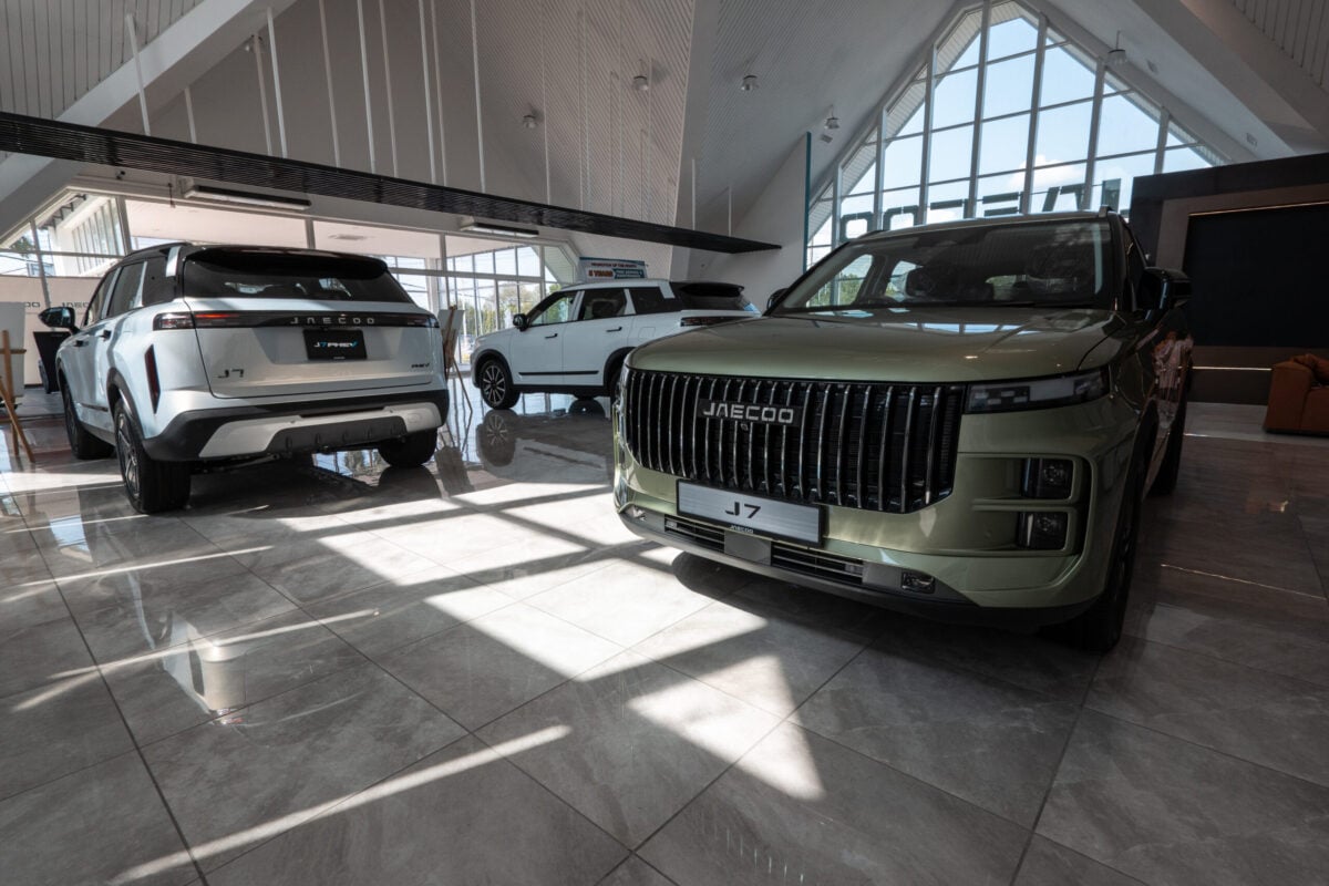 car dealership flooring showcased on the showroom floor, highlighting automotive retail and luxury vehicles