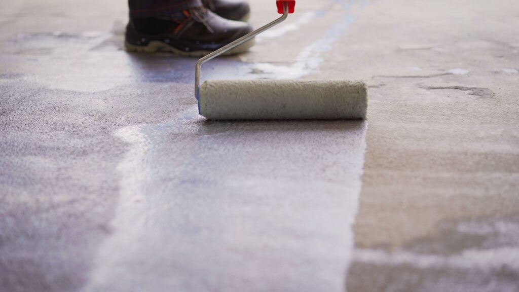 Floor priming process. Priming Concrete floor before laying tiles on it, the final preparatory stage for strengthening the surface