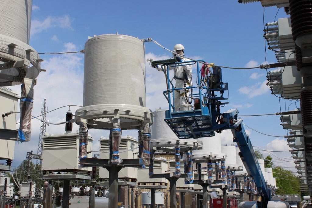 worker painting white tank