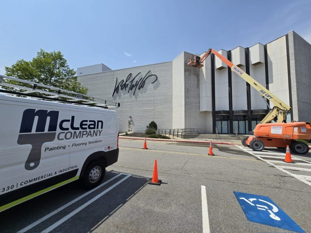 commercial exterior painting contractor branded truck parked outside building