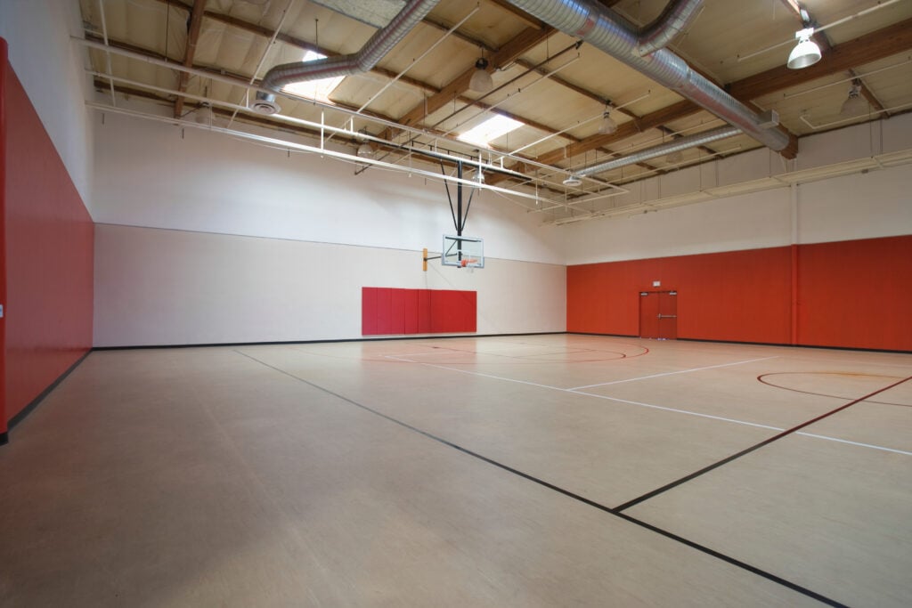sports hall flooring View of an empty basketball court at gymnasium